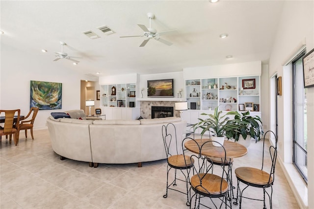 tiled living room with ceiling fan and lofted ceiling