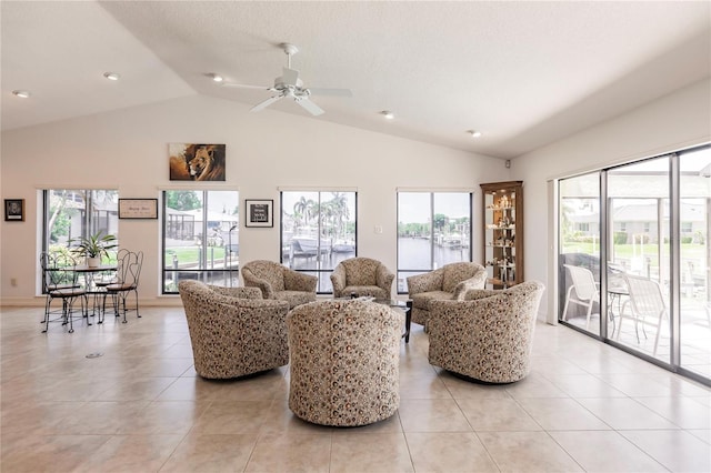 living room with ceiling fan, light tile patterned floors, and a wealth of natural light