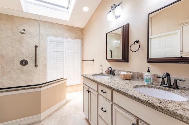 bathroom featuring tile patterned floors, lofted ceiling with skylight, vanity, and tiled shower