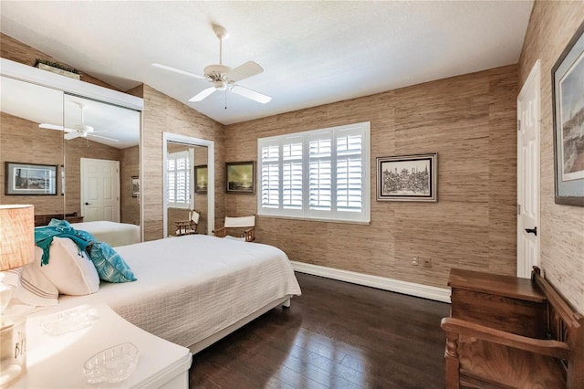 bedroom with a closet, ceiling fan, dark hardwood / wood-style flooring, and vaulted ceiling