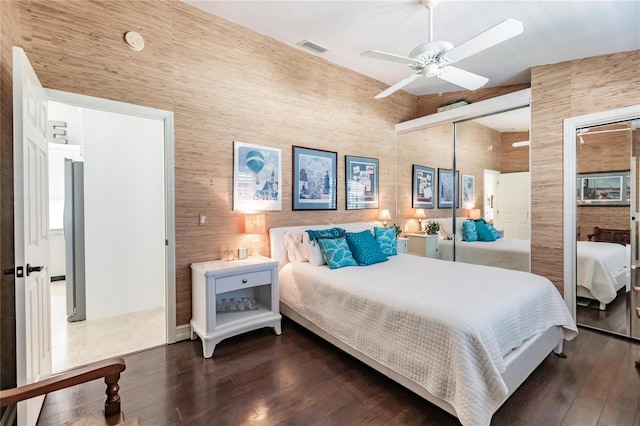 bedroom featuring ceiling fan, a closet, and dark wood-type flooring