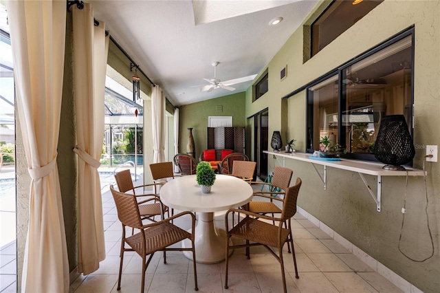 dining area featuring vaulted ceiling, ceiling fan, and light tile patterned flooring