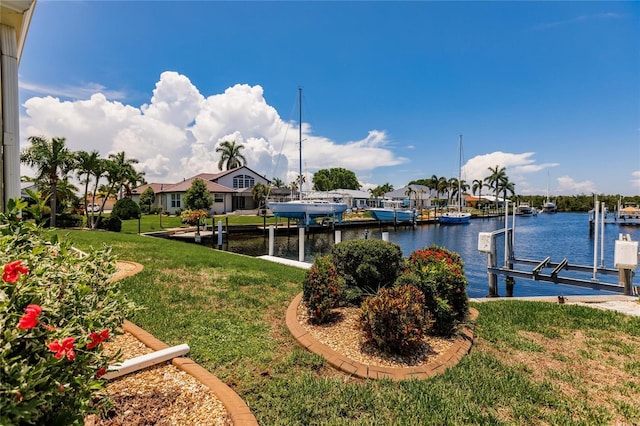 dock area with a yard and a water view