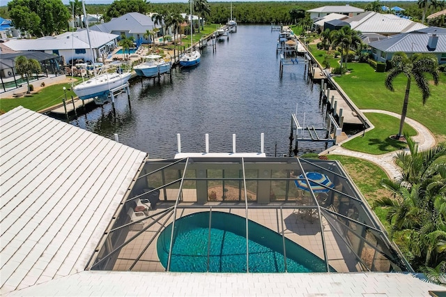 exterior space with glass enclosure and a water view