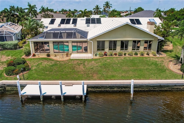 rear view of property featuring a lanai, a yard, and a water view