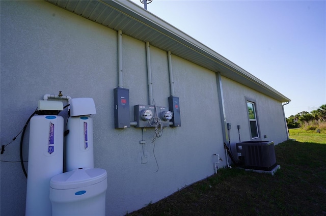 view of side of home with central AC