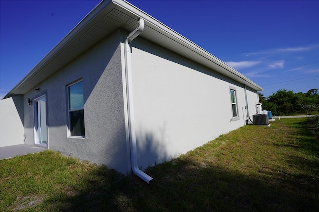 view of side of home with a yard