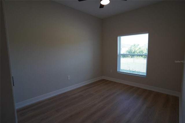 spare room with ceiling fan and dark hardwood / wood-style floors