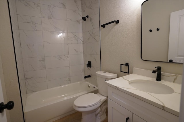 full bathroom with toilet, vanity, and tiled shower / bath