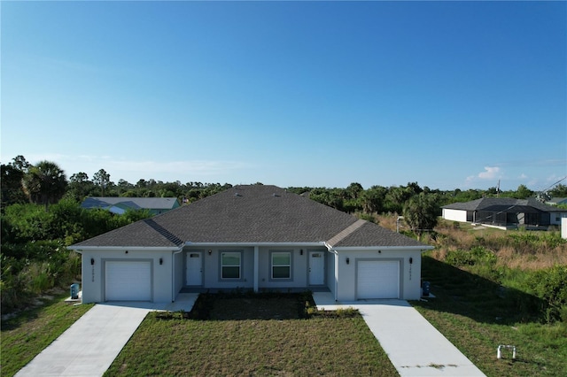 ranch-style home with a garage and a front yard