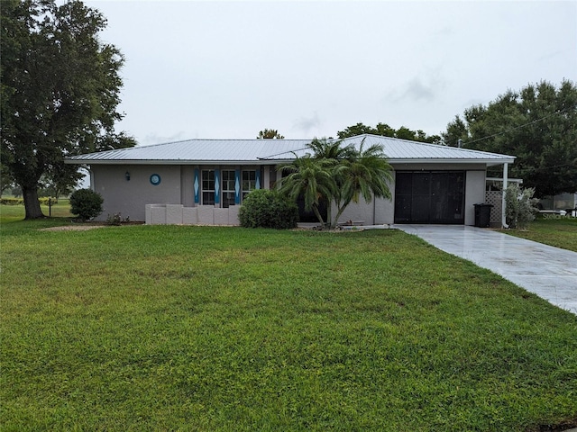 single story home featuring a front lawn and a garage