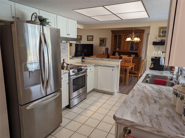 kitchen featuring sink, white cabinets, light tile floors, and appliances with stainless steel finishes