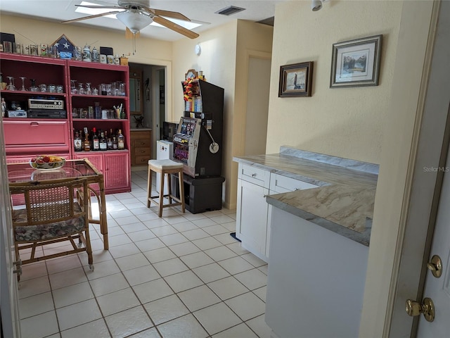 interior space with ceiling fan and light tile floors