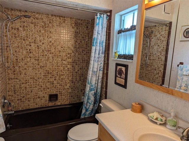 full bathroom featuring vanity with extensive cabinet space, toilet, and shower / bath combo