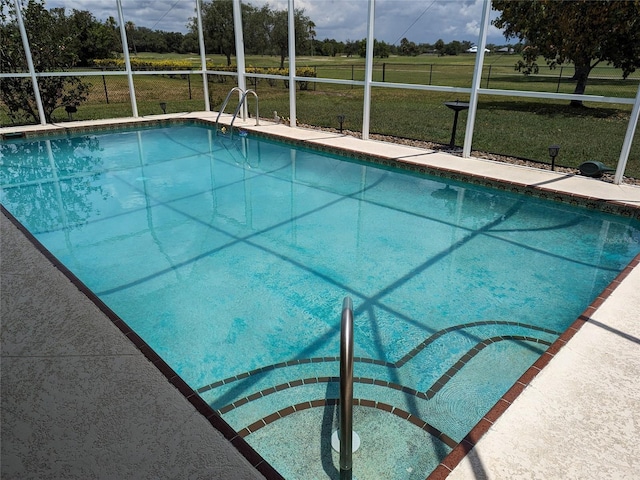 view of swimming pool featuring a lawn