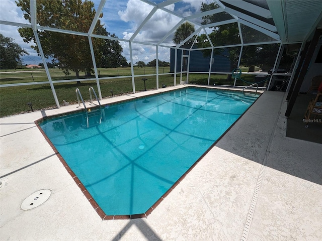 view of swimming pool featuring a patio, a lanai, and a yard