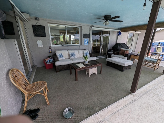 exterior space with ceiling fan and a textured ceiling