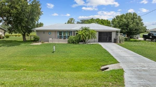 single story home featuring a front yard and a garage