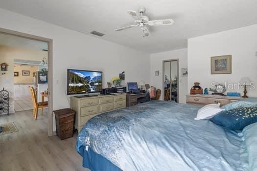 bedroom with hardwood / wood-style flooring and ceiling fan