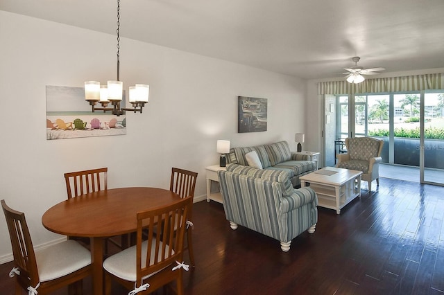 living room featuring dark hardwood / wood-style flooring and ceiling fan with notable chandelier