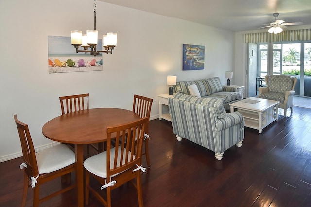 dining space featuring ceiling fan with notable chandelier and dark wood-type flooring