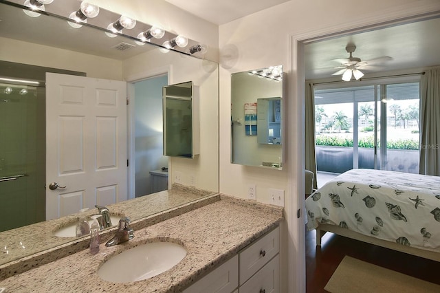 bathroom with ceiling fan, an enclosed shower, and vanity