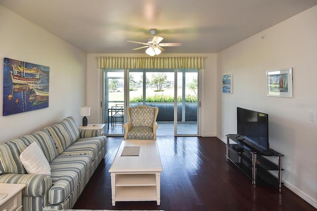 living room with ceiling fan and dark wood-type flooring