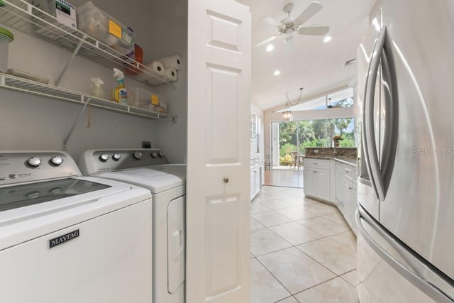 laundry area featuring light tile patterned floors, separate washer and dryer, and ceiling fan