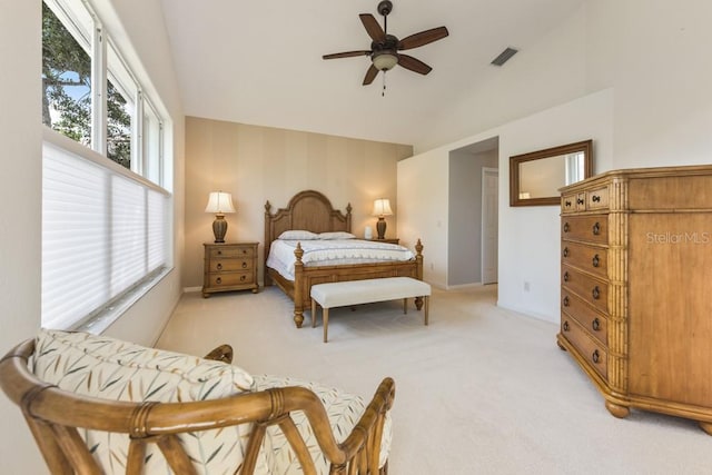 bedroom featuring ceiling fan, light colored carpet, and vaulted ceiling