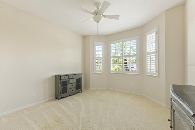 unfurnished room featuring light carpet and ceiling fan