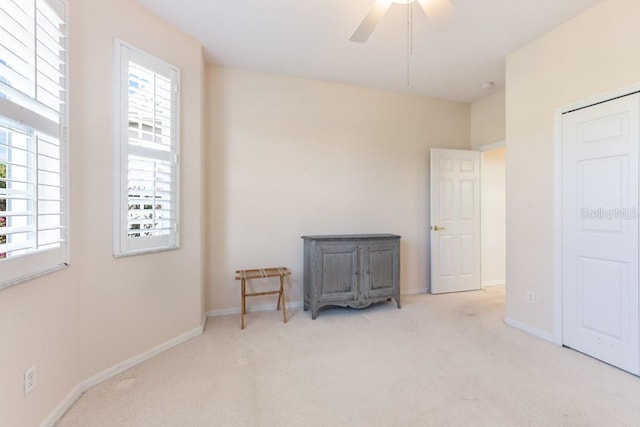 bedroom featuring ceiling fan and light colored carpet