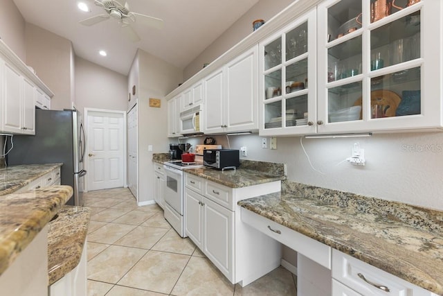 kitchen with white cabinets, white appliances, ceiling fan, and dark stone counters