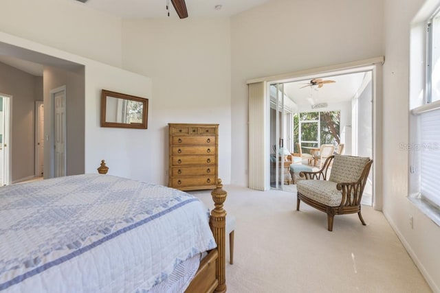 bedroom with ceiling fan, light colored carpet, and vaulted ceiling