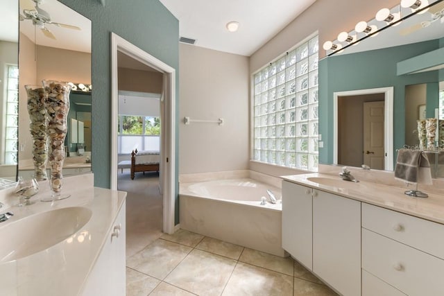 bathroom with tile patterned flooring, a bathtub, ceiling fan, and vanity