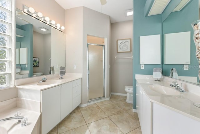 bathroom featuring ceiling fan, tile patterned floors, toilet, vanity, and a shower with shower door