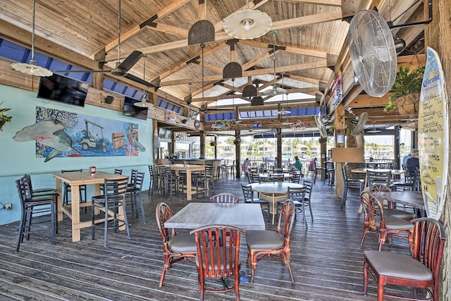 dining space featuring wooden ceiling, high vaulted ceiling, ceiling fan, beamed ceiling, and dark hardwood / wood-style flooring