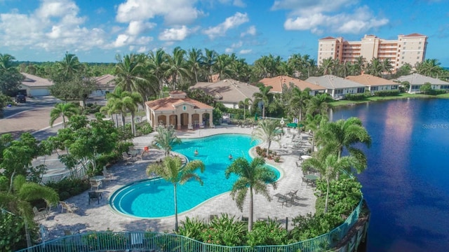 view of swimming pool featuring a water view and a patio area