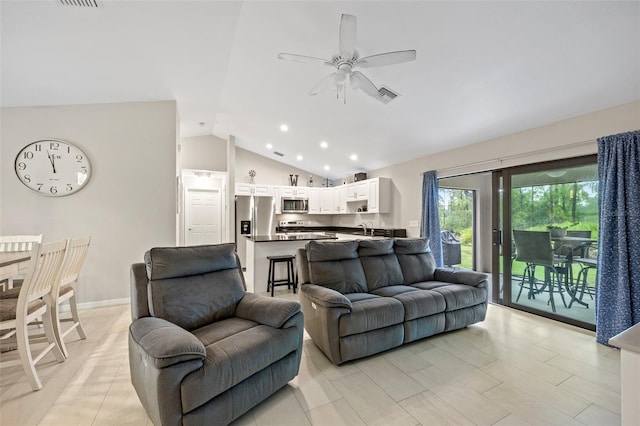 living room with ceiling fan, sink, and lofted ceiling