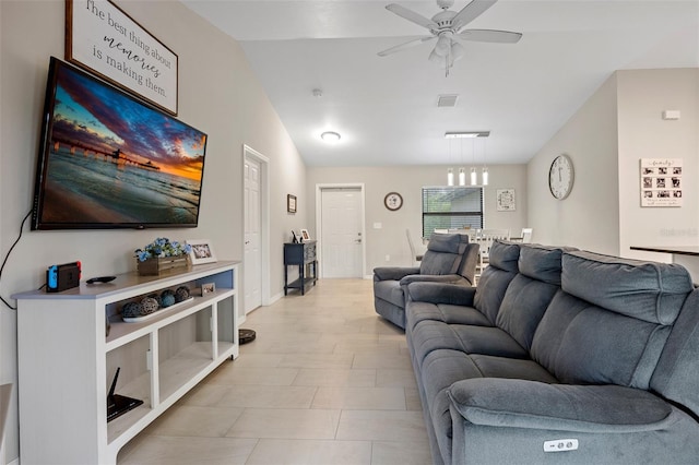 tiled living room featuring ceiling fan and lofted ceiling