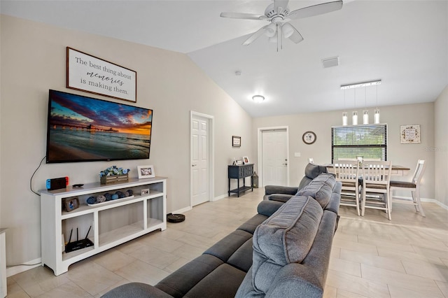 tiled living room with ceiling fan and lofted ceiling