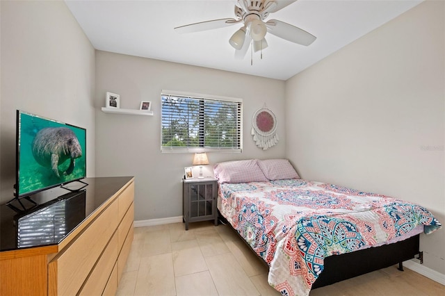 tiled bedroom featuring ceiling fan