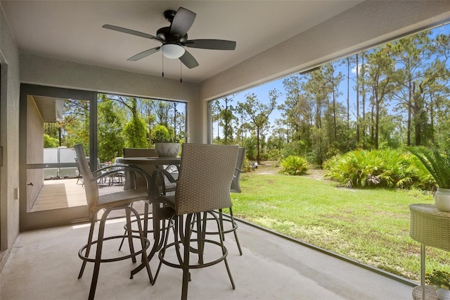 sunroom featuring ceiling fan