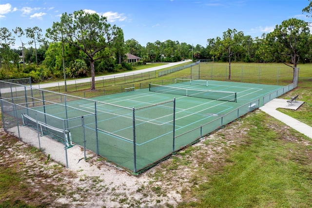 view of sport court with a lawn