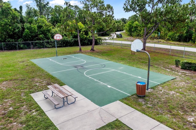 view of basketball court featuring a lawn