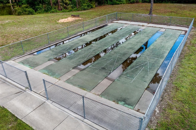 view of swimming pool with a lawn