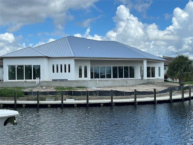 back of house featuring a water view