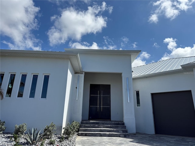 doorway to property with a garage