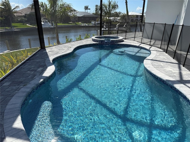 view of pool with a water view, glass enclosure, and an in ground hot tub