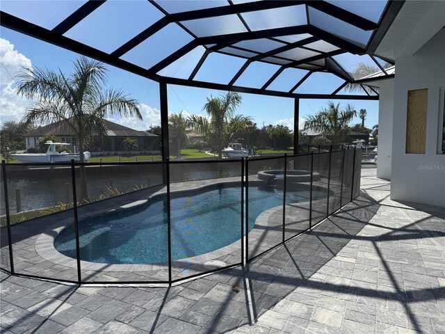 view of pool featuring a water view, an in ground hot tub, a lanai, and a patio area