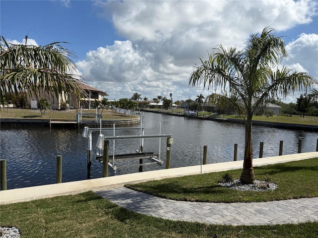 dock area with a water view and a yard